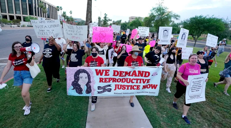 Protesters march around the Arizona Capitol after the Supreme Court's decision to overturn Roe v. Wade on Friday, June 24, 2022, in Phoenix. 